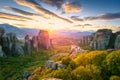 Meteora, Greece. Panoramic landscape of Meteora, Greece at romantic sundown time with real sun and sunset sky. Meteora -