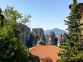 Meteora Greece. Picturesque rocks and tiled roof of house against blue sky. Travel, vacation. Beauty in nature, mountain landscape