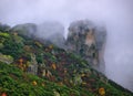 Meteora, Greece, winter dramatic landscape with heavy clouds and foggy mountains. Vibrant colorful nature Royalty Free Stock Photo