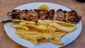 Meteora -  Greek souvlaki served in traditional restaurant in Meteora, Greece. Meat on skewers Royalty Free Stock Photo