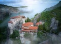 Meteora Monastery of Roussanou rising out of the mist. Aerial, mystical panoramic landscape. A UNESCO Site. Greece Royalty Free Stock Photo