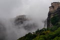 Meteora - Panoramic view of Holy Monastery of Varlaam and Monastery of Rousanou surrounded by misty fog