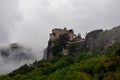 Meteora - Panoramic view of Holy Monastery of Varlaam and Monastery of Rousanou surrounded by misty fog