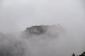 Meteora - Panoramic view of Holy Monastery of Varlaam surrounded by misty fog on cloudy day, Kalambaka, Meteora Royalty Free Stock Photo