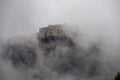 Meteora - Panoramic view of Holy Monastery of Varlaam surrounded by misty fog on cloudy day, Kalambaka, Meteora