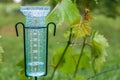 Meteorology with rain gauge in garden after the rain Royalty Free Stock Photo