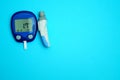 The meter is blue with very low sugar (hypoglycemia) on a white background. Copy space.