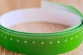 Meter tape for measuring rolled into a roll, on a light background. Selective focus. Royalty Free Stock Photo