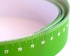 Meter tape for measuring rolled into a roll, on a light background. Selective focus Royalty Free Stock Photo