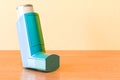 Metered-dose inhaler, MDI on the wooden table, 3D rendering Royalty Free Stock Photo