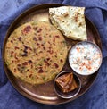 Punjabi thali - Paratha flatbread served with accompaniments Royalty Free Stock Photo