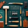 Meticulously arranged assortment of leathercraft tools on a green Royalty Free Stock Photo