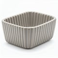 Elegant ribbed ceramic container, minimalist design for home decor display on white background Royalty Free Stock Photo