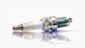 A meticulously detailed spark plug, isolated against a white background, embodies precision and innovation Royalty Free Stock Photo