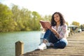 Metis woman reading a book in outdoor