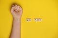 MeToo on wooden alphabet, used for concept of sexual harrassment. Woman fist as protest in shot Royalty Free Stock Photo