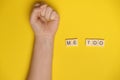 MeToo on wooden alphabet, used for concept of sexual harrassment. Woman fist as protest in shot Royalty Free Stock Photo