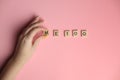 Woman hand making MeToo word with wooden alphabet on pink background, used for concept of sexual harrassment Royalty Free Stock Photo