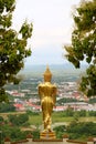 Golden Buddha image in walking posture of Wat Phra That Khao Noi, a hilltop temple in Nan Province, Thailand Royalty Free Stock Photo