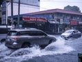 A Toyota Fortuner plows through flash floods caused by heavy rainfall. Monsoon season or thunderclouds.
