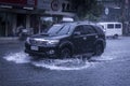 A Toyota Fortuner wades through flash floods caused by heavy rains. Monsoon season