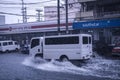 Metro Manila, Philippines - A van drives through flash floods caused by heavy rainfall. Monsoon season or thunderclouds