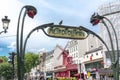 Metro sign and Moulin Rouge cabaret in Paris, France Royalty Free Stock Photo