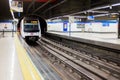 Metro train arrives at Madrid metro platform in Chamartin Station