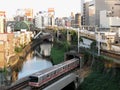 Metro train crossing river in one of central areas of Tokyo