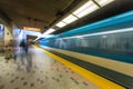 A metro train transit runs by as the people wait. The Montreal Metro (MÃÂ©tro de MontrÃÂ©al), Quebec, Canada Royalty Free Stock Photo