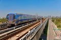 A metro train travels on the elevated rails of Taoyuan Mass Rapid Transit System Airport MRT on a beautiful sunny day Royalty Free Stock Photo