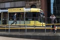 Metrolink tram arriving on the platform at St Peters Square Station.  Public Transport Vehicle.  People in shot Royalty Free Stock Photo