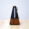 Metronome in action, closeup, and on a plain background Royalty Free Stock Photo