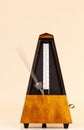 Metronome On Light Background With Blurred Arm Moving Fast Royalty Free Stock Photo