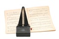 Metronome on sheet music background Royalty Free Stock Photo