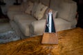 A Metronome on Top of a Walnut Veneer Table in a Drawing Room
