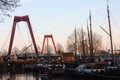 The metropolitan city of Rotterdam is tinged with orange and warm colors at sunset. tourists admire the attraction point of the