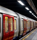 Train on the platform at Euston Square Underground Station, London UK, showing reflection of train on ceiling above. Royalty Free Stock Photo