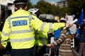 Metropolitan Police officer helping members of the public with their enquiries.