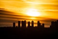Metrotown silhouette on sunset cloudy sky background.