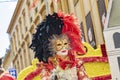 people enjoy the performance at the The Mirabelle Plum Festival in Metz, France. people in venetian costumes perform a parade