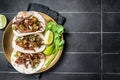 Mexican Beef Barbacoa Tacos with Cilantro and Onion. Black background. Top view. Copy space