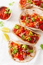 Mexican beef and pork tacos with salsa, guacamole and vegetables