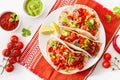 Mexican beef and pork tacos with salsa, guacamole and vegetables