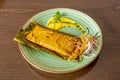 Mexican beef tamale with purple onion, chili sauce, stewed in banana leaf