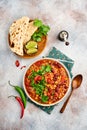 Mexican black bean soup with minced meat, tomato, cilantro, avocado and vegetables stew on a light grey slate, stone or concrete b Royalty Free Stock Photo