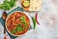 Mexican black bean soup with minced meat, tomato, cilantro, avocado and vegetables stew on a light grey slate, stone or concrete b Royalty Free Stock Photo