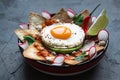 Mexican breakfast: chilaquiles with egg, avocado and vegetables close-up on a plate Royalty Free Stock Photo