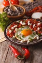 Mexican breakfast: huevos rancheros close-up. vertical