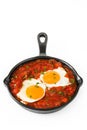 Mexican breakfast: Huevos rancheros in iron frying pan isolated Royalty Free Stock Photo